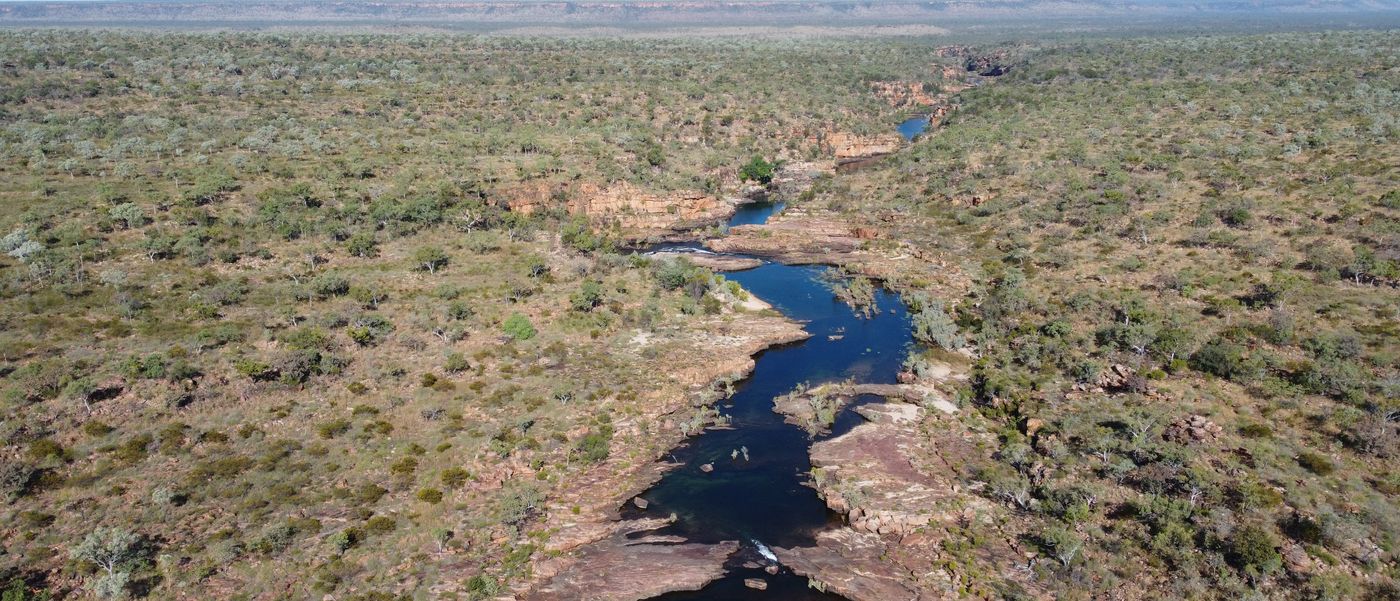 Aerial view of a river cutting through Western Australian country.